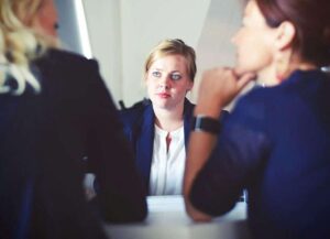Blog three women sitting beside table