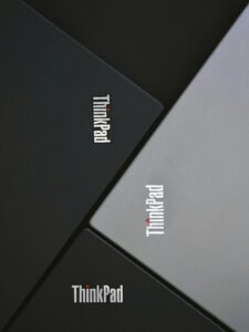 Blog Close-up of three Lenovo ThinkPad laptops angled stylishly. Modern and sleek product photography.